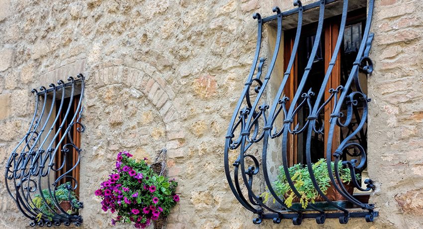 Wrought iron bars on the windows: decoration and reliable protection of the house